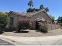 View of the property's backyard with gravel landscaping and a cinderblock fence at 6631 E Rhodes St, Mesa, AZ 85215