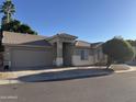 Charming single-story home with a well-maintained front yard and attached two-car garage at 6631 E Rhodes St, Mesa, AZ 85215