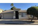 Charming single-story home with a well-maintained front yard and attached two-car garage at 6631 E Rhodes St, Mesa, AZ 85215