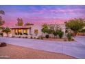 Charming single-story home exterior with desert landscaping, and a circular driveway at 6831 E Presidio Rd, Scottsdale, AZ 85254