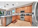 Kitchen with wooden cabinets, stainless steel appliances, and tile flooring at 747 E Meadow Ln, Phoenix, AZ 85022