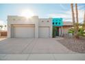 Charming home with a two-car garage, xeriscaping, and a striking turquoise-accented entryway at 988 W Crooked Stick Dr, Casa Grande, AZ 85122