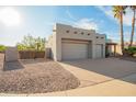 Southwestern home displaying a two-car garage, rock lawn, and gated side yard at 988 W Crooked Stick Dr, Casa Grande, AZ 85122