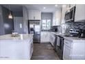 Bright kitchen features white cabinets, stainless steel appliances, and a functional layout at 1017 W Piccadilly Rd, Phoenix, AZ 85013