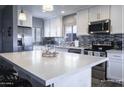 Modern kitchen boasts white cabinets, stainless steel appliances, and stylish backsplash at 1017 W Piccadilly Rd, Phoenix, AZ 85013