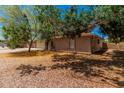 Well-maintained brick home with an arched entryway and lush landscaping, offering privacy and style at 1170 E Carmen St, Tempe, AZ 85283