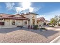 Beautiful home with desert landscaping, red tiled roof, and arched entry way at 12899 W Pasadena Ave, Litchfield Park, AZ 85340