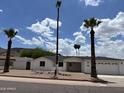 Charming single-story home featuring a two-car garage, palm trees, and desert landscaping at 1423 W Joan De Arc Ave, Phoenix, AZ 85029