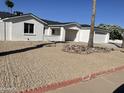 Charming single-story home with a xeriscaped front yard and attached two car garage at 1423 W Joan De Arc Ave, Phoenix, AZ 85029