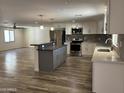 Open-concept kitchen features stainless steel appliances and a center island with countertop seating at 1423 W Joan De Arc Ave, Phoenix, AZ 85029