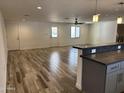 Spacious living room showcasing wood-look floors, modern lighting and abundant natural light at 1423 W Joan De Arc Ave, Phoenix, AZ 85029