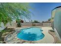 Inviting backyard pool surrounded by trees and landscaping at 1423 W Joan De Arc Ave, Phoenix, AZ 85029