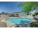 Backyard pool with desert landscaping in a private yard at 1423 W Joan De Arc Ave, Phoenix, AZ 85029