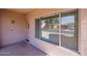 Inviting front porch with large windows providing natural light and pleasant outdoor views at 14552 W Hearn Rd, Surprise, AZ 85379