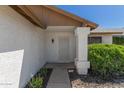 Close up of front door with security screen, column and front yard landscaping at 1633 E Beverly Ln, Phoenix, AZ 85022