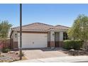 Inviting single-story home with a tile roof, brick driveway, two car garage, and desert landscaping at 16521 W Magdalena Ln, Goodyear, AZ 85338