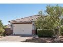 Attractive single-story home with a tile roof and well-manicured landscaping, enhancing curb appeal at 16521 W Magdalena Ln, Goodyear, AZ 85338