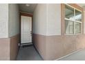 Inviting covered porch featuring neutral tones and a welcoming front door at 16521 W Magdalena Ln, Goodyear, AZ 85338