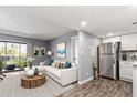 Inviting living area open to the kitchen, showcasing sleek appliances and contemporary decor at 1730 W Emelita Ave # 2027, Mesa, AZ 85202