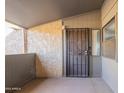 Private patio with secure entry door and textured walls at 1730 W Emelita Ave # 2027, Mesa, AZ 85202