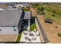 Scenic aerial perspective of a backyard featuring a fire pit, outdoor kitchen, and access to a lush green golf course at 17362 W Wildwood St, Surprise, AZ 85388