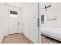 Bright entryway with elegant tile flooring, a modern door, and a view into the bedroom at 17362 W Wildwood St, Surprise, AZ 85388