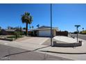 Well-maintained home showcasing desert landscaping, a paved driveway, and a convenient street corner location at 17415 N 57Th Ave, Glendale, AZ 85308