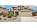 Charming two-story home featuring a well-manicured front yard and attached two-car garage at 17681 W Molly Ln, Surprise, AZ 85387