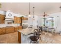 Bright kitchen featuring travertine floors, granite counters, and a breakfast nook at 18226 W Marshall Ct, Litchfield Park, AZ 85340