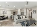 Bright living room with modern gray sofa, open floor plan, and tile flooring at 1829 N 43Rd Ter, Phoenix, AZ 85008