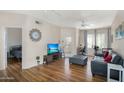 Comfortable living room with hardwood floors and a door leading to a bedroom at 18416 N Cave Creek Rd # 3034, Phoenix, AZ 85032
