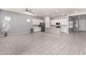 Bright, open-concept kitchen featuring a large island, stainless steel appliances, and modern white cabinets at 18508 W Galveston St, Goodyear, AZ 85338