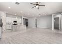 Spacious open-concept living area with tile flooring, seamlessly connecting the kitchen and living spaces at 18508 W Galveston St, Goodyear, AZ 85338