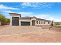 A well-maintained home featuring a three-car garage and a paved driveway at 19622 W Pasadena Ave, Litchfield Park, AZ 85340