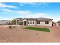 An inviting single-Gathering home featuring desert landscaping and a three-car garage at 19622 W Pasadena Ave, Litchfield Park, AZ 85340