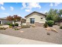 Charming home featuring desert landscaping with cacti, shrubs, and a decorative stone accent at 20140 N 269Th Dr, Buckeye, AZ 85396