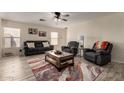 Inviting living room with neutral walls, wood-look tile floors, comfortable seating, and a ceiling fan at 22745 W Cocopah St, Buckeye, AZ 85326