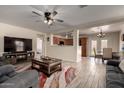 Cozy living room with an open layout, features a fireplace, tile floors, and access to a casual dining area at 22745 W Cocopah St, Buckeye, AZ 85326