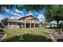 Large, well-maintained backyard with green grass, mature trees and an upper level balcony at 2307 W Sienna Bouquet Pl, Phoenix, AZ 85085