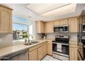 Well-lit kitchen featuring stainless steel appliances, generous counter space, and a bright window with neighborhood views at 2834 S Extension Rd # 2001, Mesa, AZ 85210