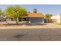 Single-Gathering home with a tidy front yard and a spacious driveway leading to an attached garage at 300 E Moore Ave, Gilbert, AZ 85234