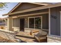Inviting front porch with a comfortable seating area and decorative brick accents, creating a welcoming entrance at 300 E Moore Ave, Gilbert, AZ 85234