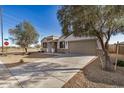 Attractive single-story home featuring a two-car garage and desert landscaping on a corner lot at 30003 W Rockmount Ave, Buckeye, AZ 85396