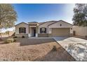 Beautiful single-story home with a desert-landscaped front yard, two-car garage, and lovely curb appeal at 30003 W Rockmount Ave, Buckeye, AZ 85396