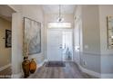 Welcoming foyer featuring high ceilings, stylish light fixtures, and modern decor creating a warm ambiance at 3070 N 148Th Dr, Goodyear, AZ 85395