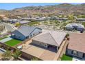 Private backyard includes an outdoor kitchen, hot tub, and mountain views at 3366 E Constance Way, Phoenix, AZ 85042