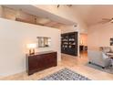 Elegant foyer with marble floors, a dark wood bookcase, and neutral-toned furniture at 3522 E Cherokee St, Phoenix, AZ 85044