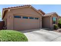 Attached two-car garage with automatic door and driveway, complemented by fresh, well-maintained landscaping at 44837 W Horse Mesa Rd, Maricopa, AZ 85139