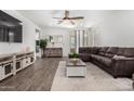 Inviting living room with hardwood floors, comfortable seating, and lots of natural light at 44837 W Horse Mesa Rd, Maricopa, AZ 85139