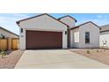 Attractive single-story home with stucco siding, a two-car garage, and a low-maintenance gravel yard at 537 E Aurora Dr, San Tan Valley, AZ 85140